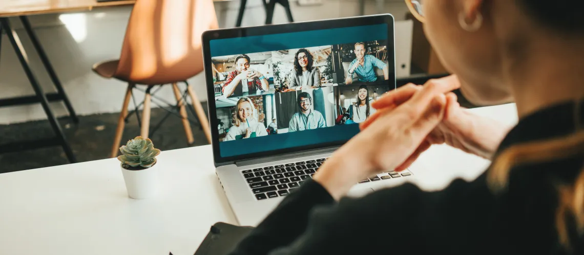 Stock image of a woman at a laptop in a video conference.