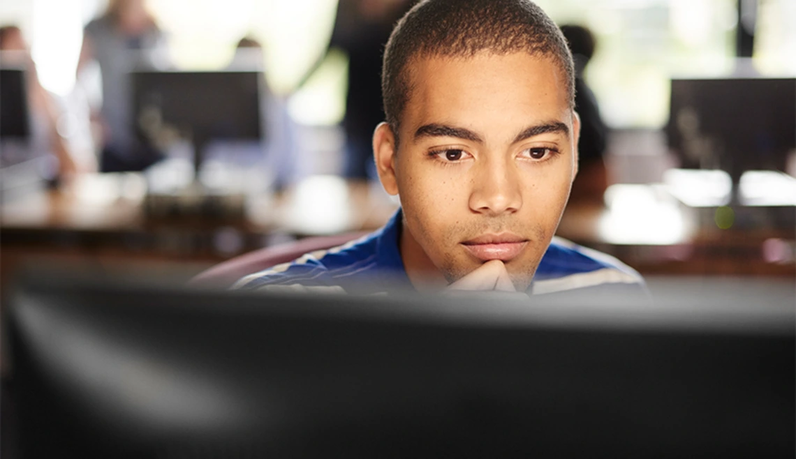Person working closely at desktop computer
