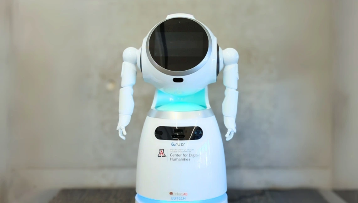 Cruzer robot stationed at the University of Arizona’s Center for Digital Humanities, featuring a sleek humanoid design with branded labels
