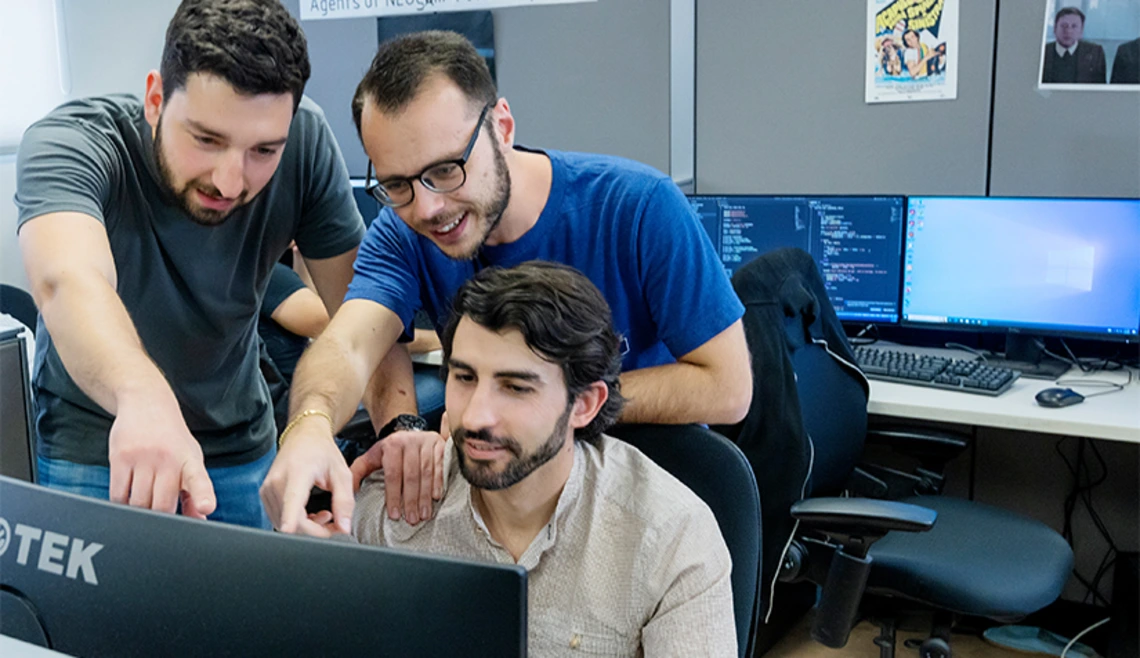 Three students working together at a computer